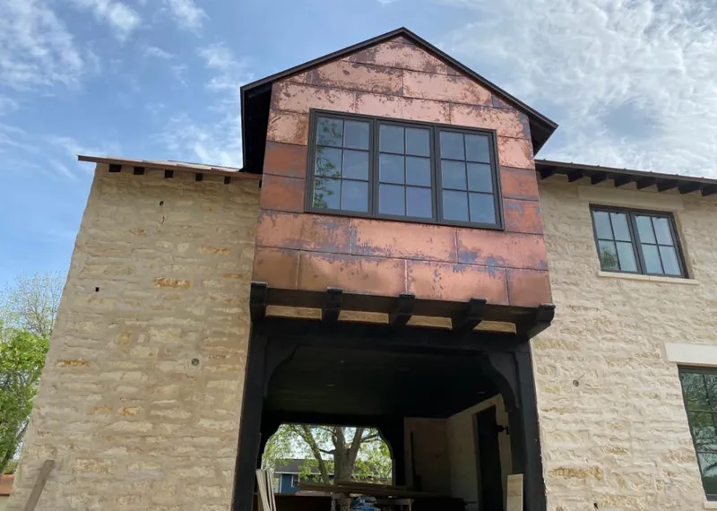 Copper metal panel facade on a stone building for Metal Roof Coating in Bloomingdale